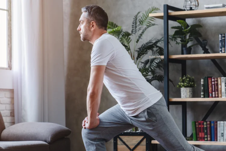 Someone doing a lunge in their living room